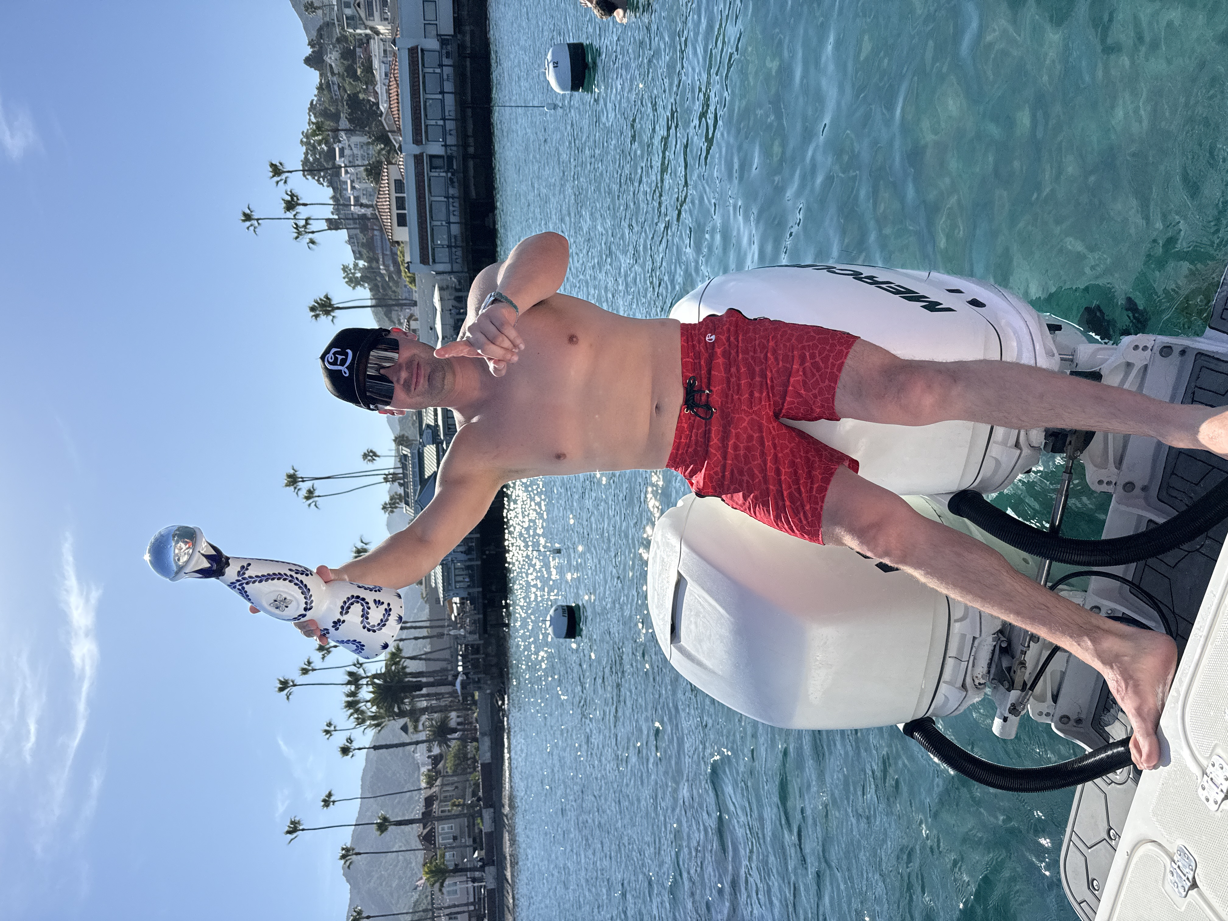 First-person view from bow of race boat with Clase Azul in hand, boats rafted up in Avalon