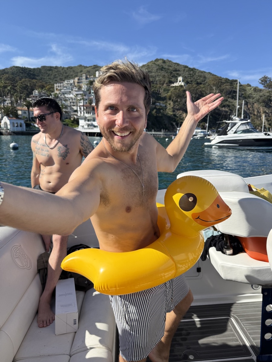 Guy laughing with giant rubber duck float in Avalon Harbor