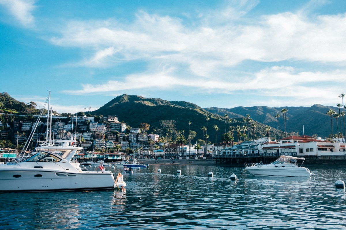 Avalon Harbor from the water with boats moored and hillside town behind